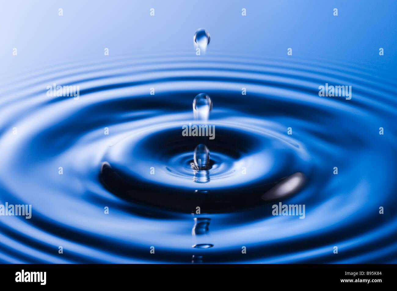Water droplet causing ripples Stock Photo