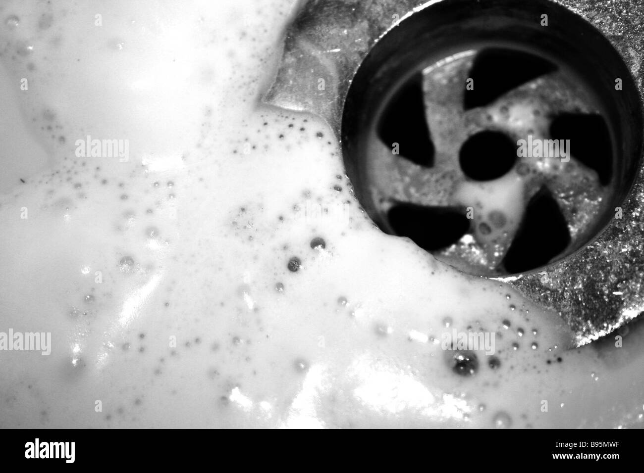 Shaving foam washing down the plug hole of a sink Stock Photo Alamy