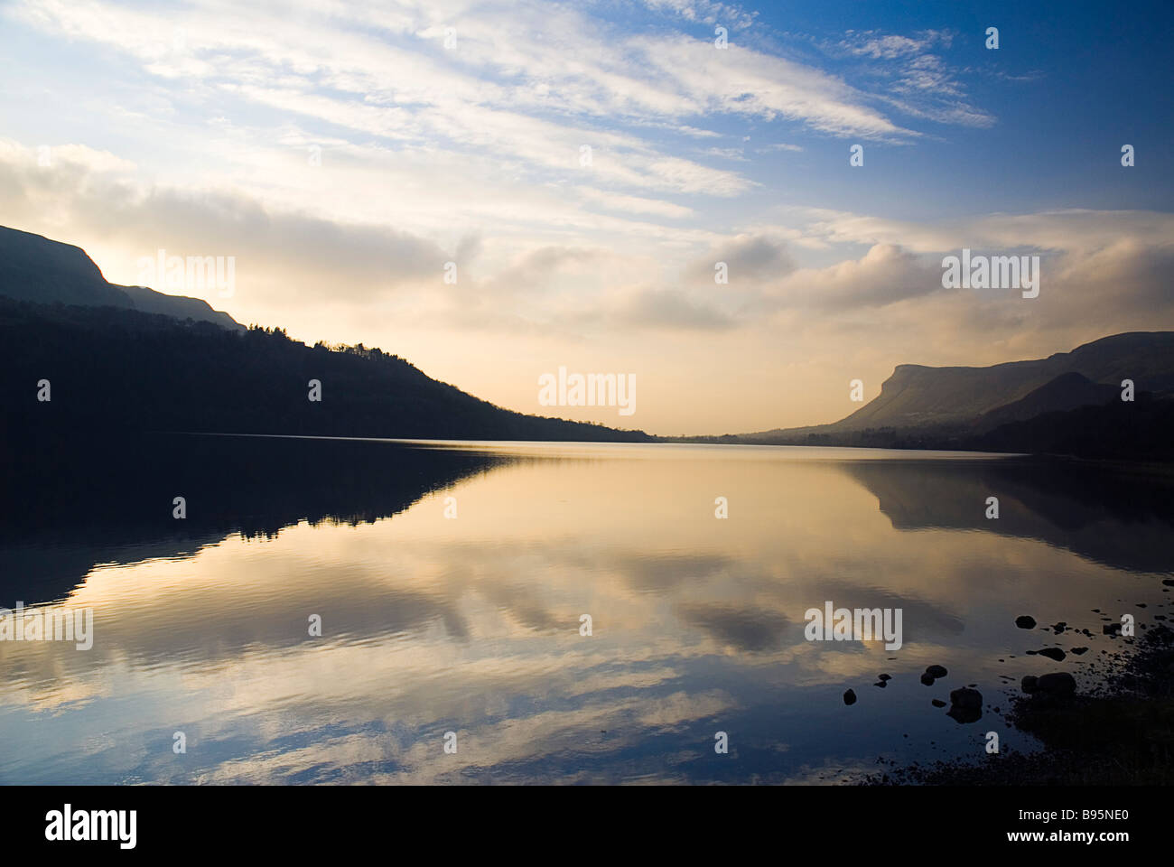 Ireland, County Leitrim, Glencar Lake in low light with Ben Bulben Mountain in County Sligo silhouetted behind. Stock Photo