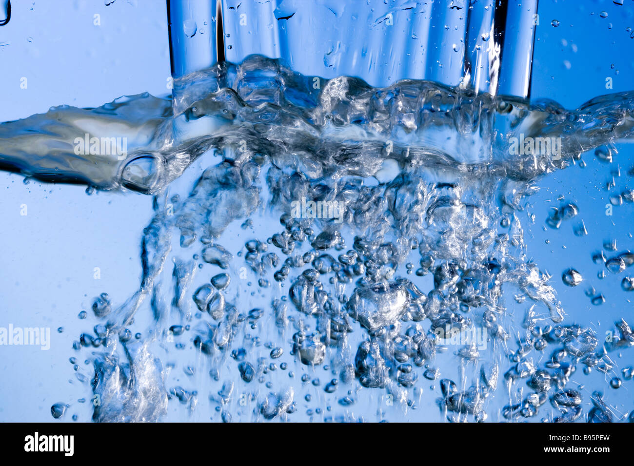 Pouring water creating bubbles Stock Photo