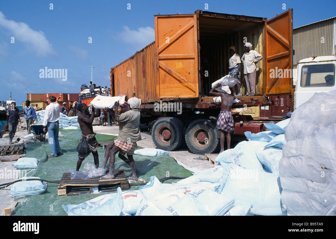 SOMALIA Mogadishu Loading French food aid of wheat flour onto truck for distribution from