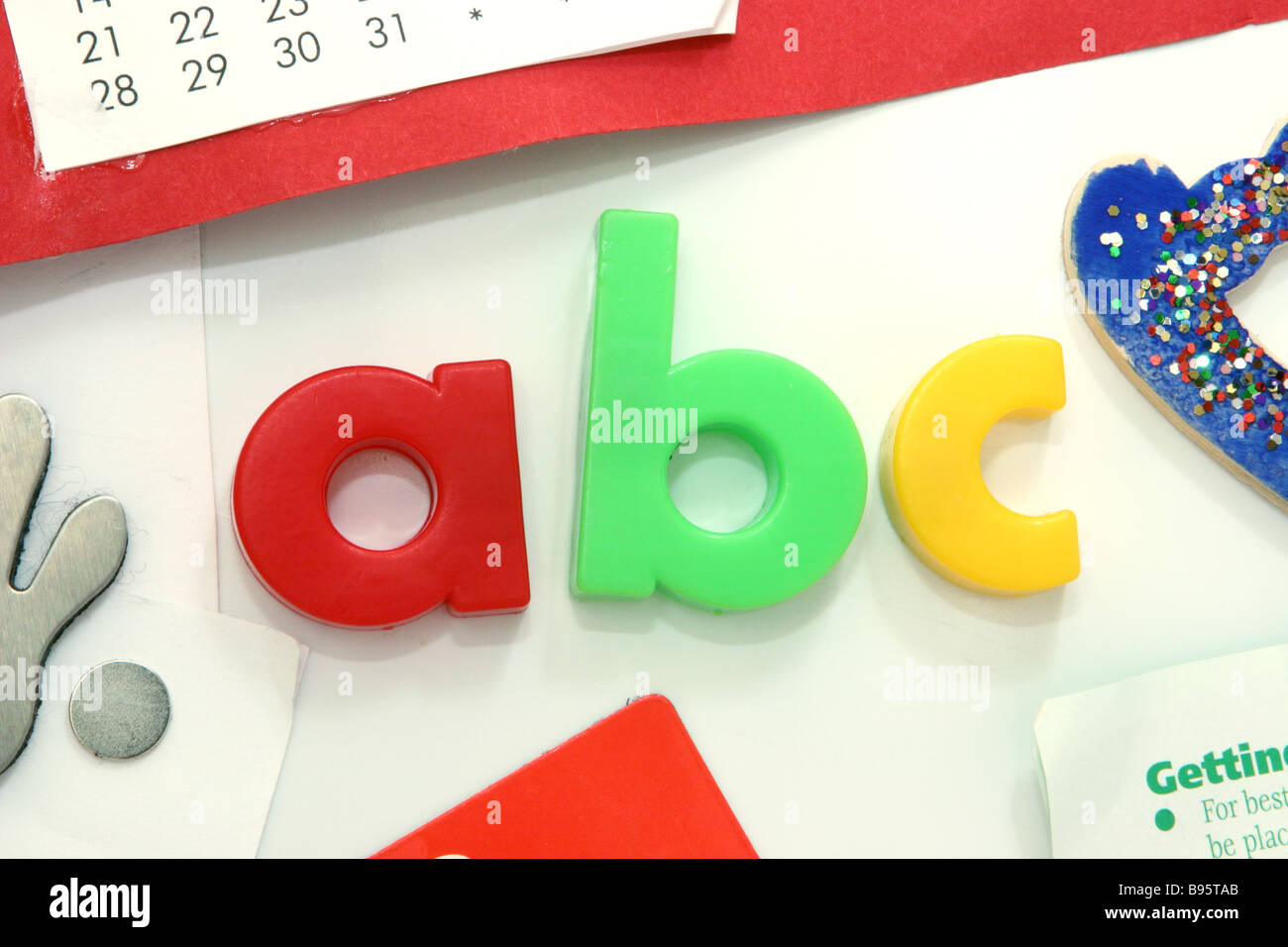 Coloured magnetic ABC Letters on a white refrigerator door Stock Photo