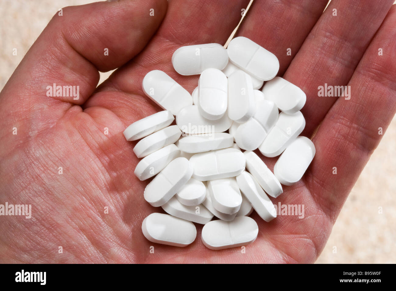 Overdose - hand full of painkillers. Stock Photo