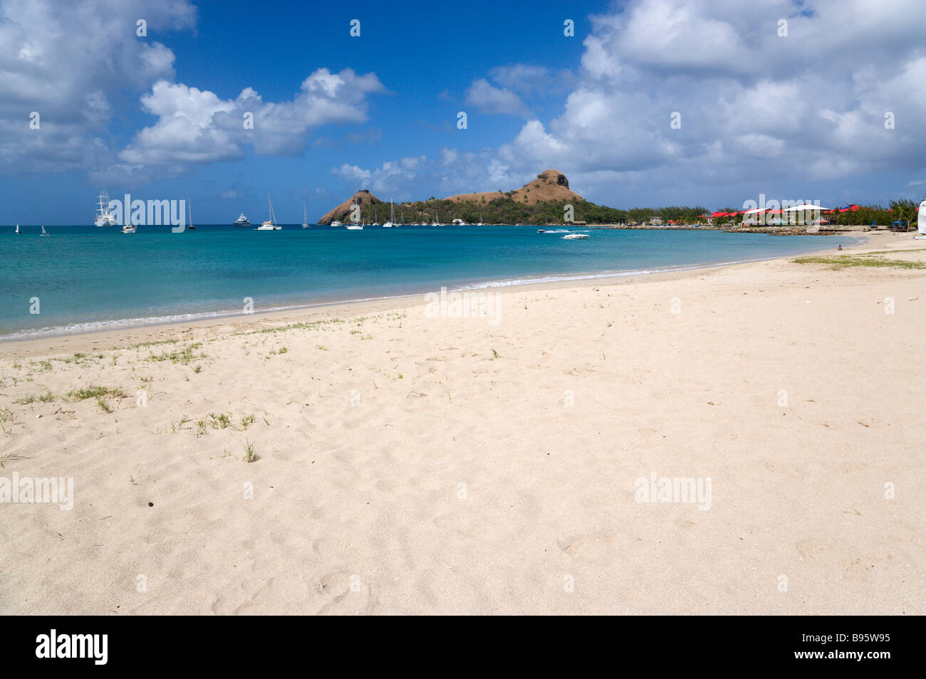 WEST INDIES Caribbean St Lucia Gros Islet Pigeon Island seen from a nearby beach on causeway Yachts at anchor in Rodney Bay Stock Photo