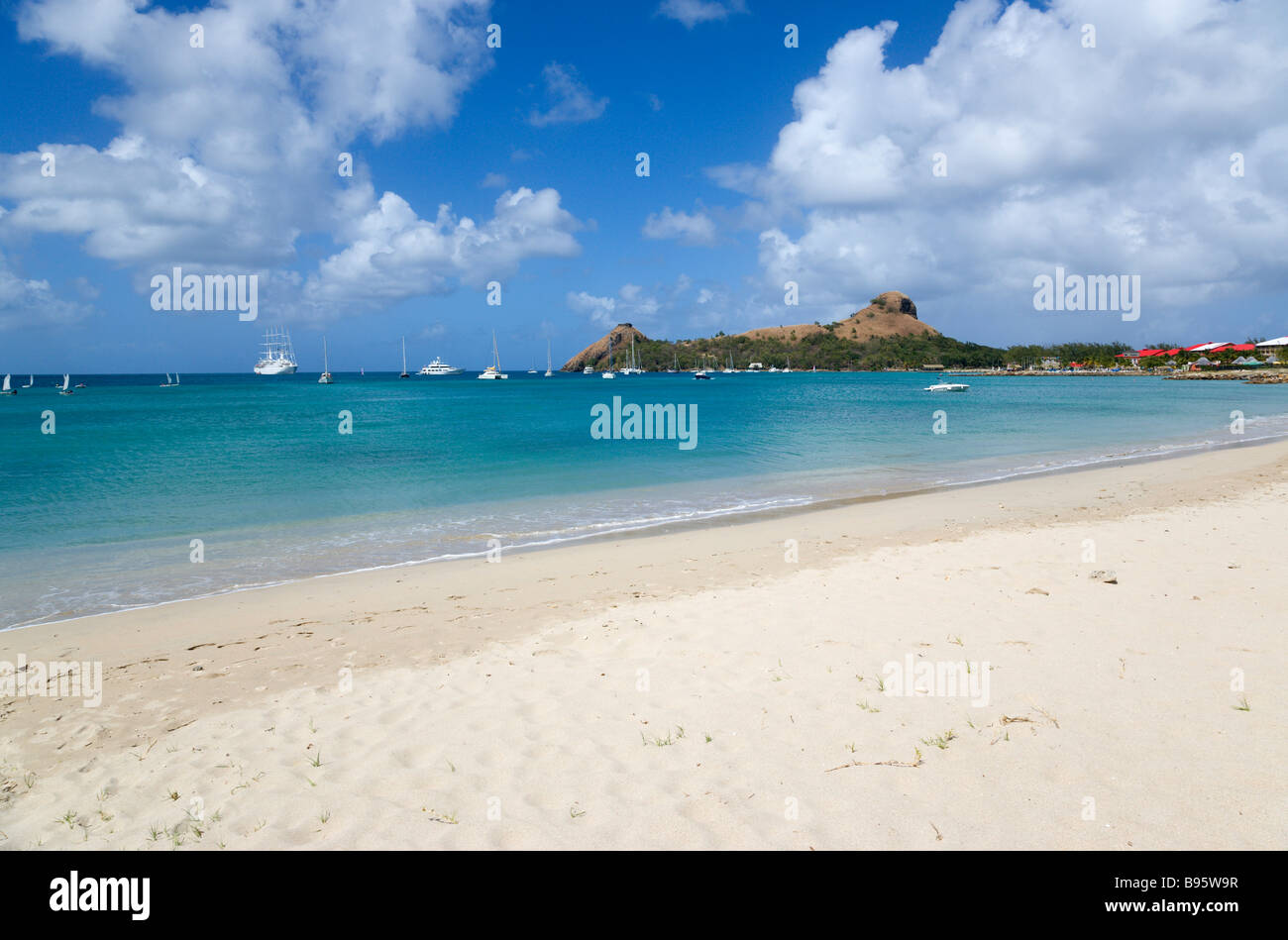 WEST INDIES Caribbean St Lucia Gros Islet Pigeon Island seen from nearby beach on causeway with yachts at anchor in Rodney Bay Stock Photo