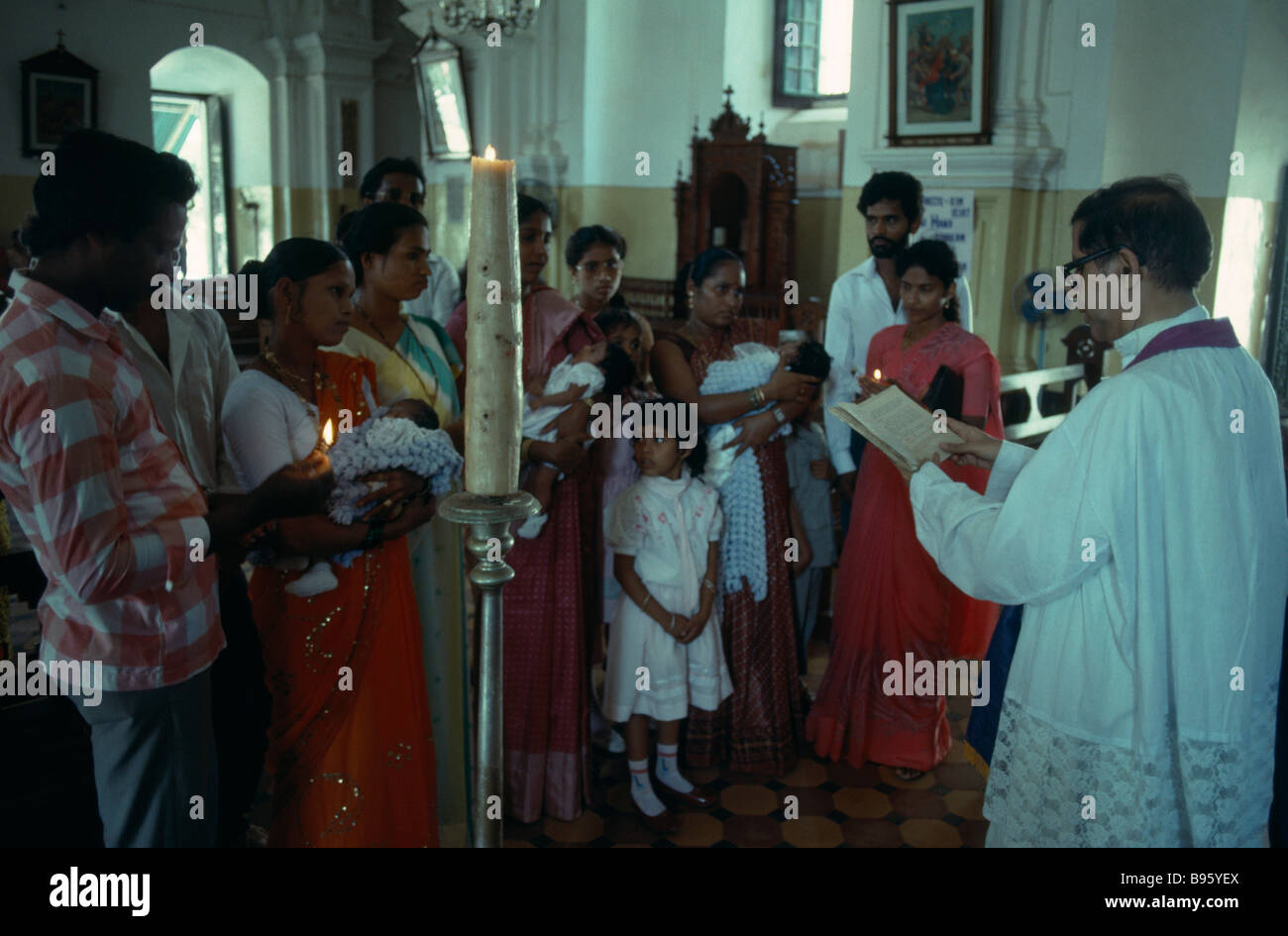 India goa margao church interior with priest conducting christening