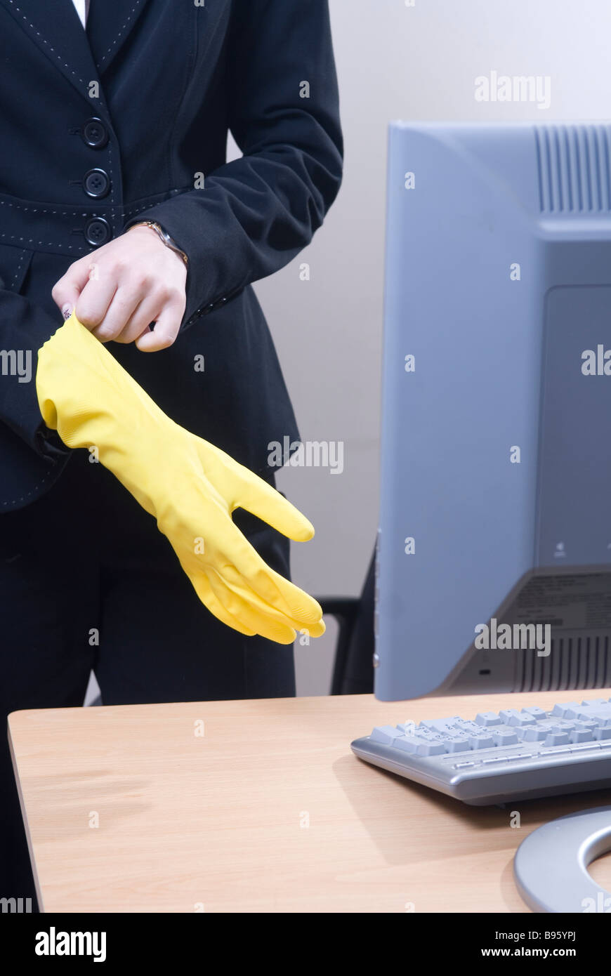 Business woman wearing yellow rubber gloves Stock Photo - Alamy