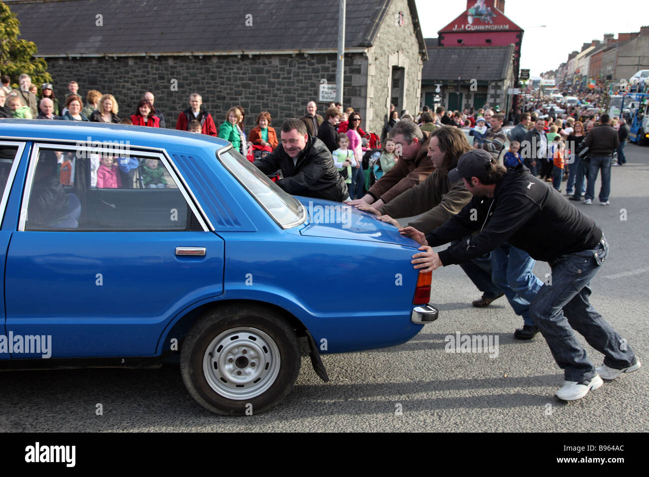 broken down car gets a push start in the St Patrick s Day Parade Carrickmacross Co Monaghan Ireland Stock Photo