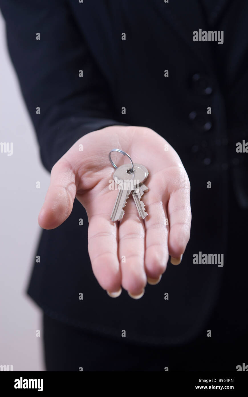 Business woman holding house keys Stock Photo - Alamy
