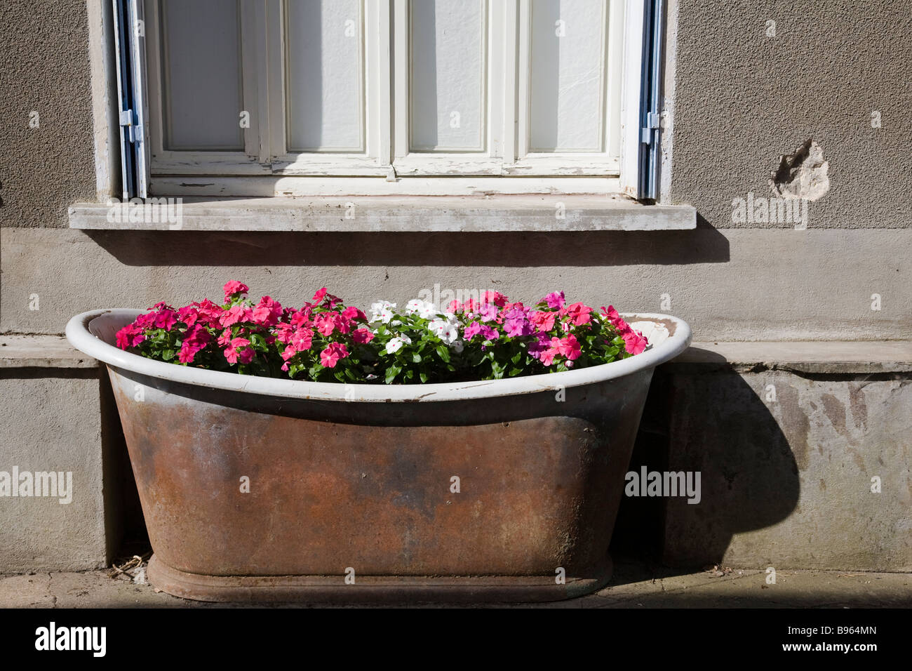 An old bath being used as a planter, Tournon d'agenais, France. Stock Photo