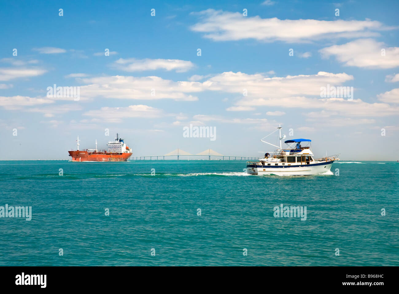 Freighter and pleasure boat in entrance to Tampa Bay from Gulf of Mexico Stock Photo