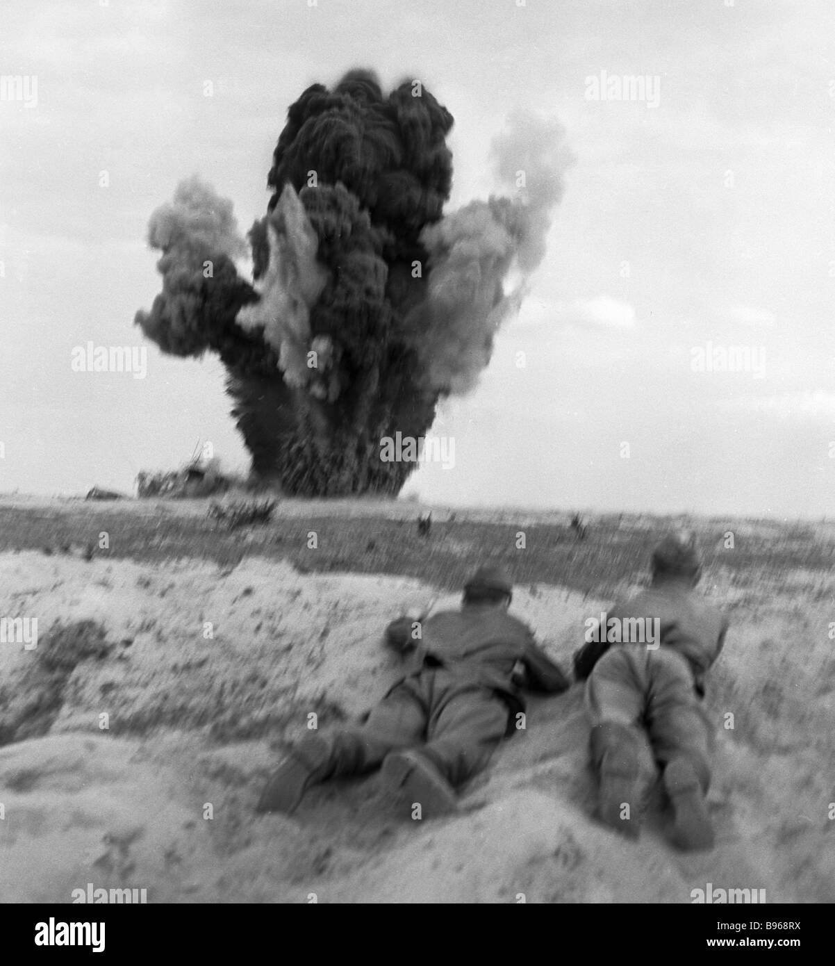 Sappers exploding shells from the munitions depot left by the Nazis in
