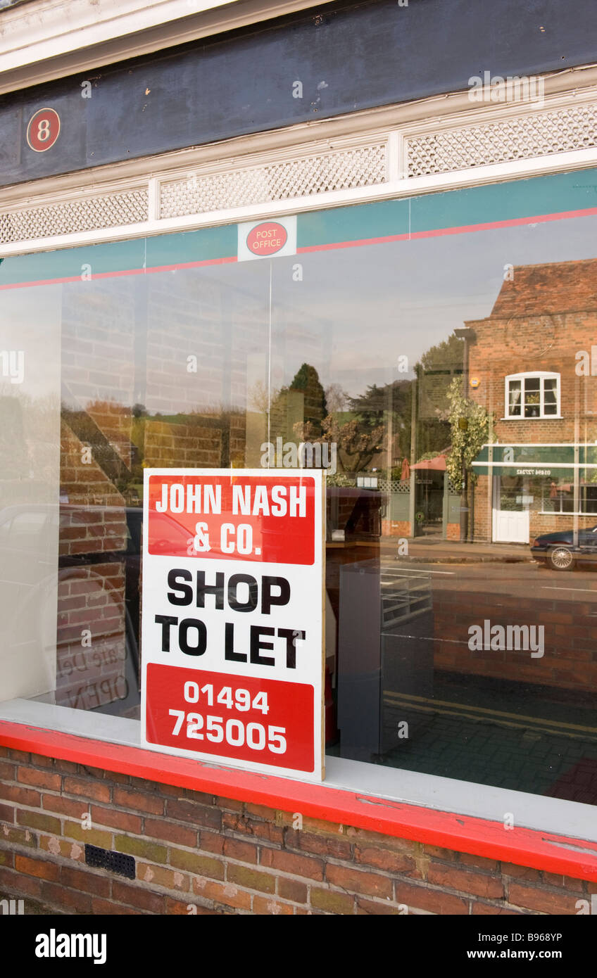 shop to let sign in a shop window, a local post office in Amersham Bucks UK closed down. Stock Photo