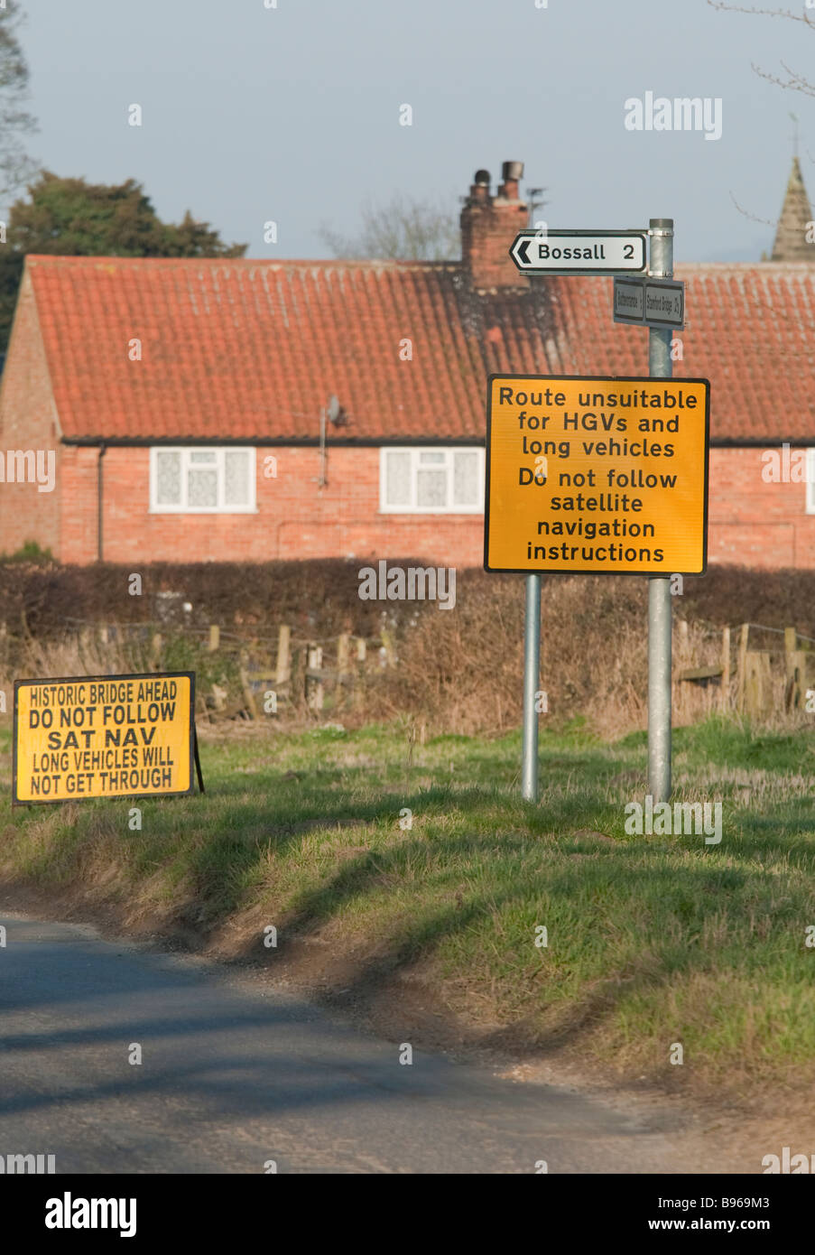 Signs at entrance to a small village warning HGV drivers to ignore satnav directions. Stock Photo