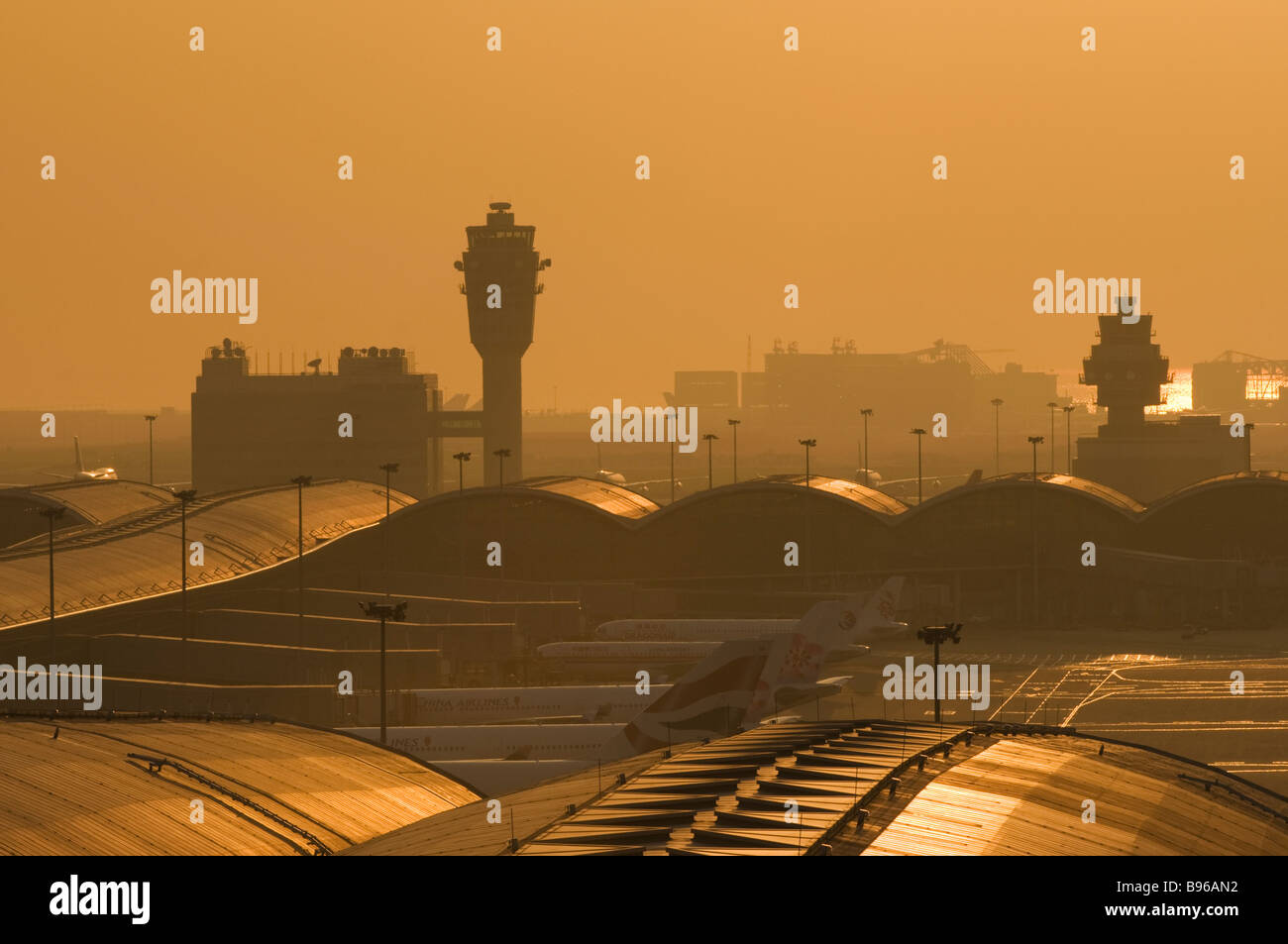 Smog shrouds Hong Kong Chek Lap Kok Airport at sunset. Stock Photo