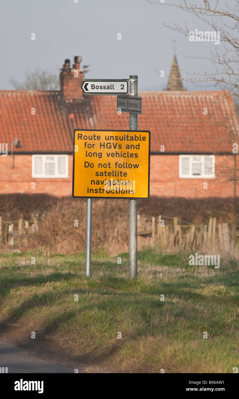 Sign at entrance to a small village warning HGV drivers to ignore satnav directions. Stock Photo