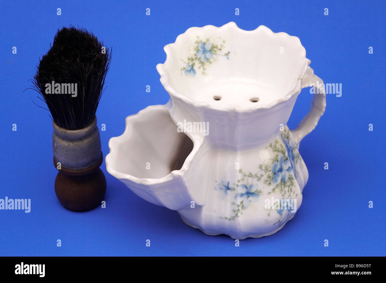 Shaving mug and brush on blue background Stock Photo Alamy