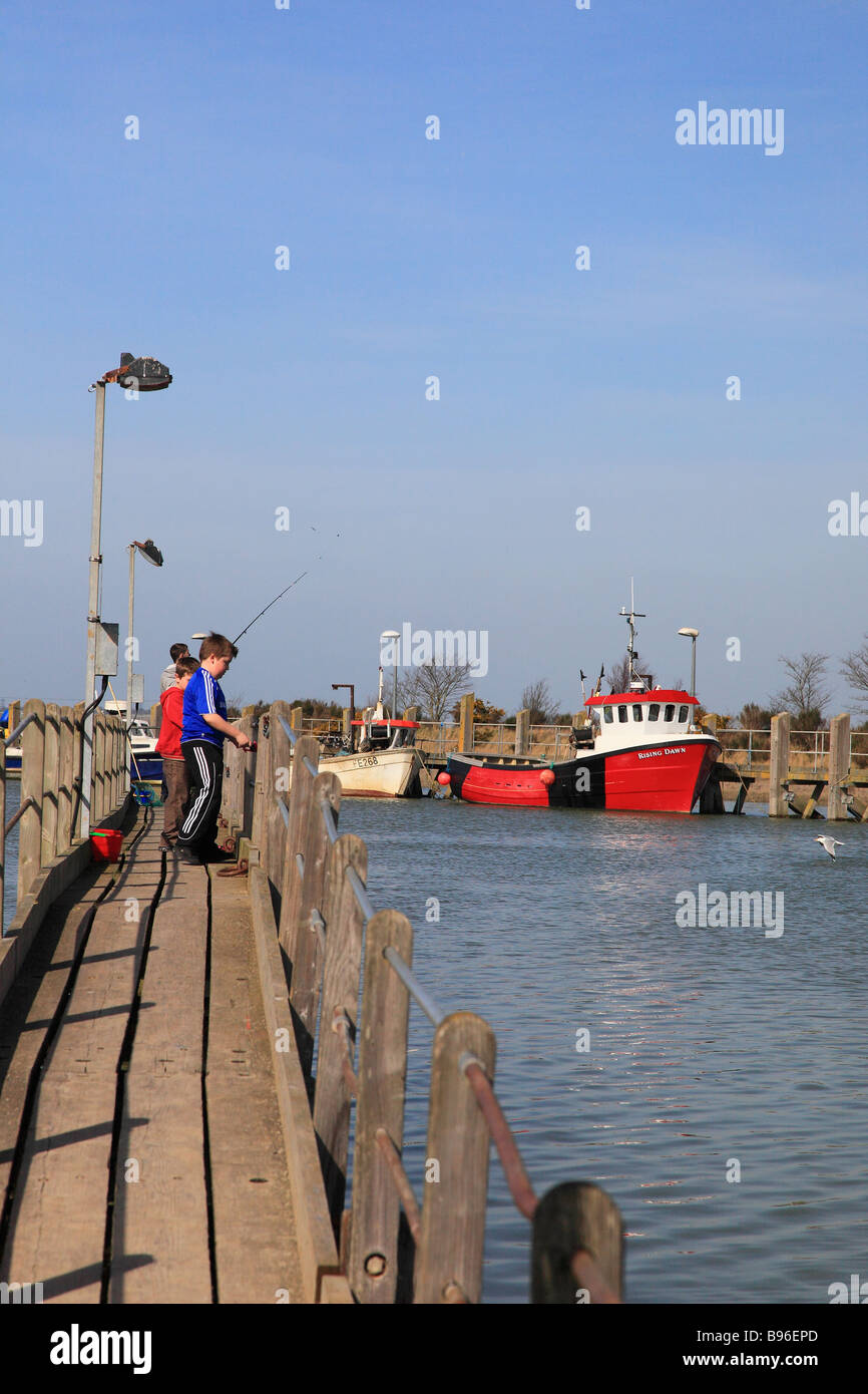 Boys fishing from the pier in Rye Harbour East Sussex  England Stock Photo
