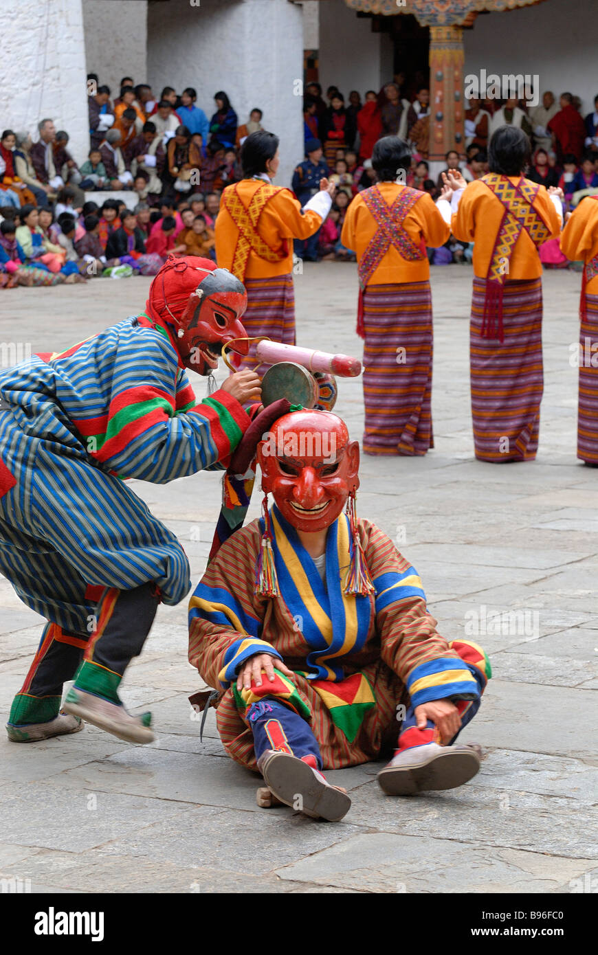 Bhutan, Punakha, Punakha Tsechu festival, Atsaras (clowns) entertaining the audience with a wooden phallus Stock Photo