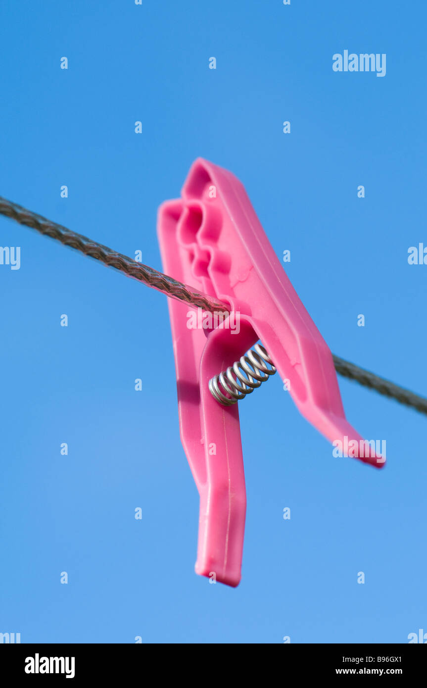 Pink peg on a washing line against a blue sky Stock Photo