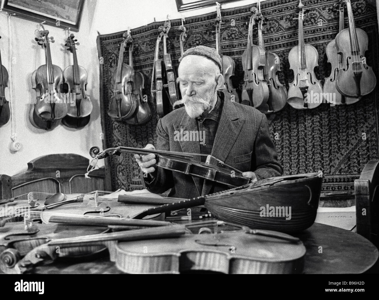 A violin maker Mikhail Arefyev in his music museum which includes the