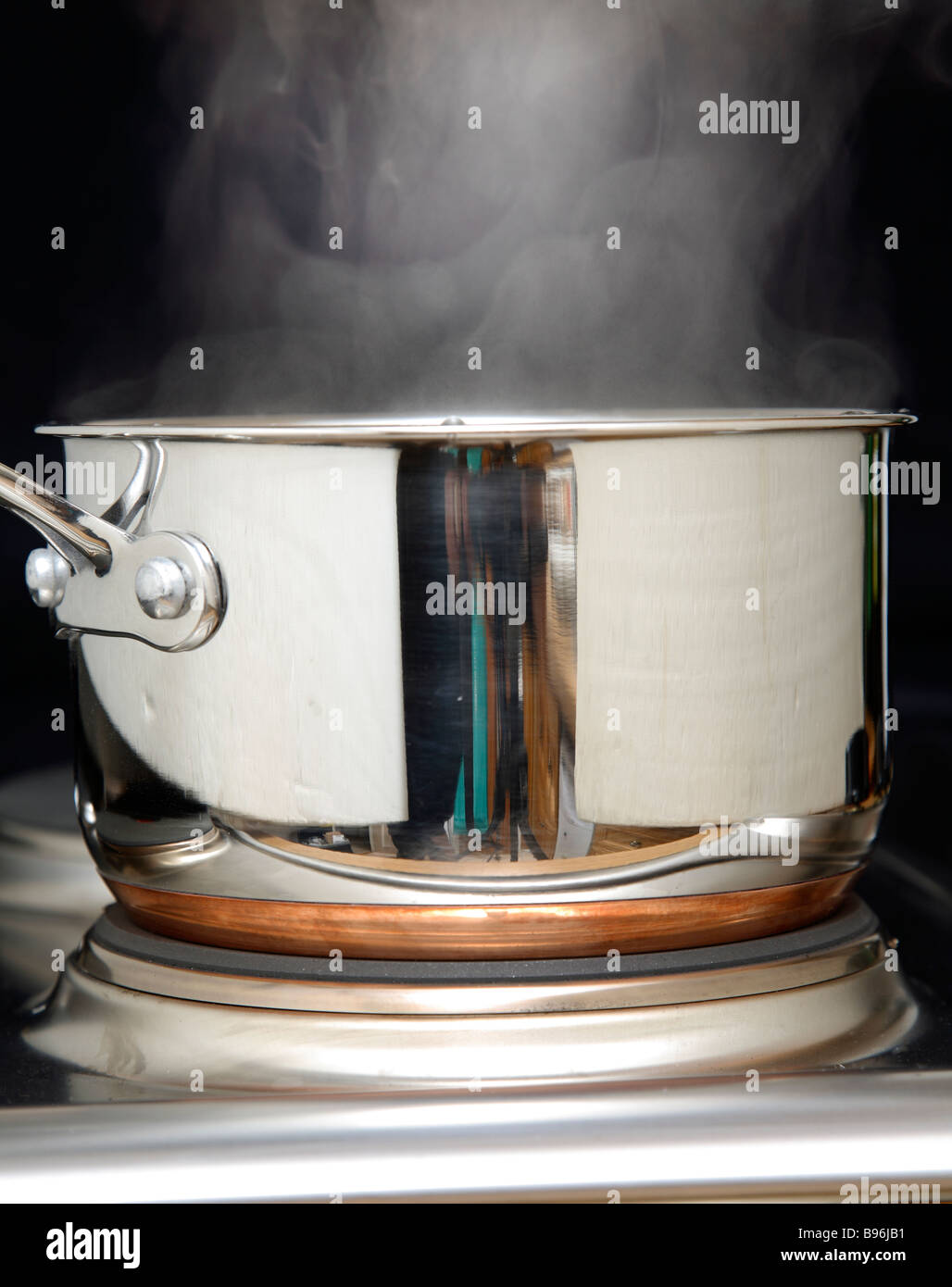 A stainless steel sausepan with steam. Stock Photo