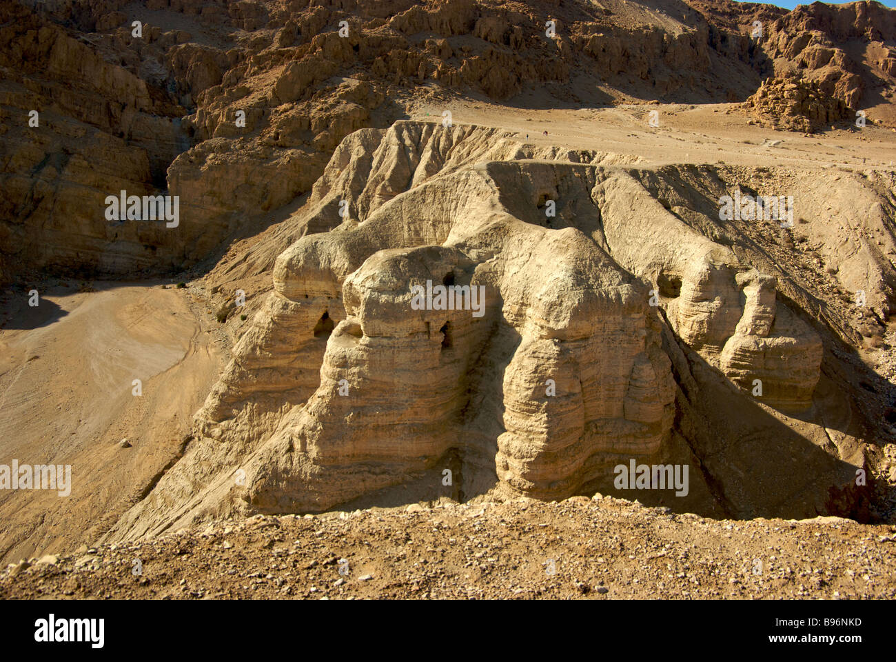 Steep cliffs to entrance of caves where Bedouin shepherds discovered jars containing Dead Sea Scrolls at Qumran National Park Stock Photo