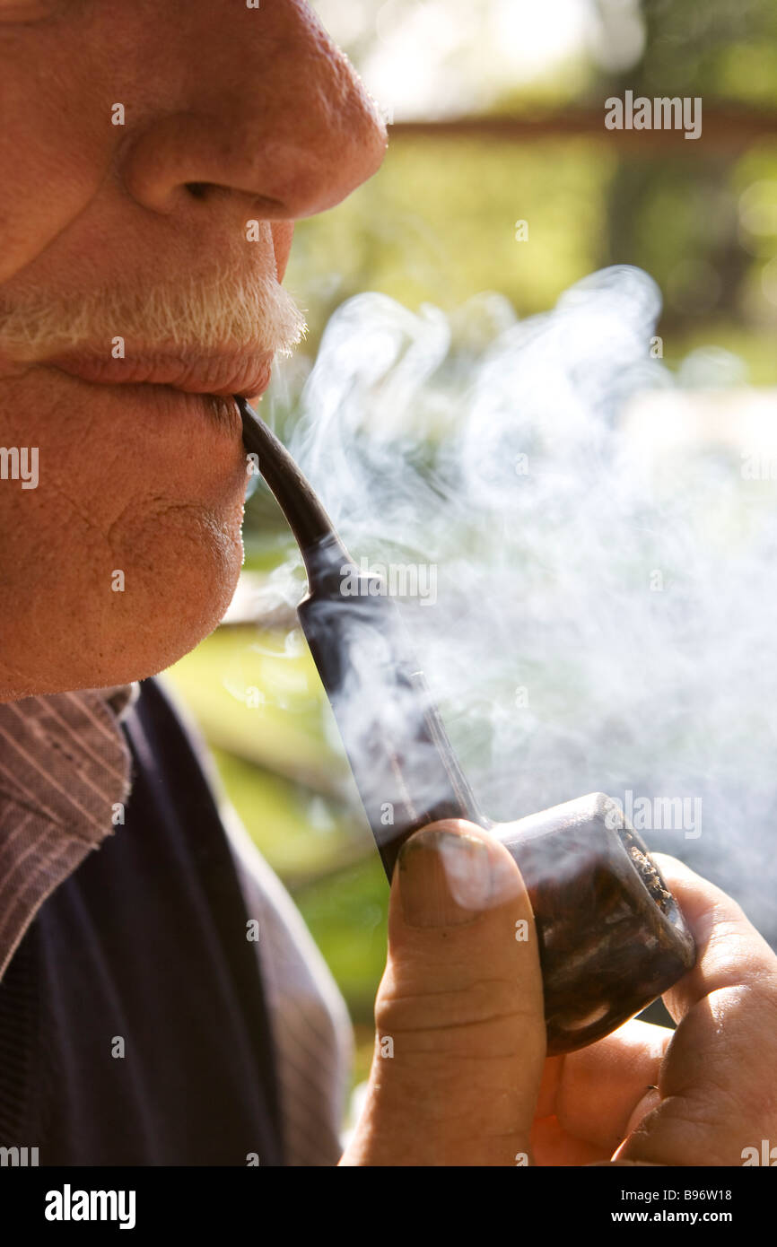 Close up of a man smoking pipe. Stock Photo