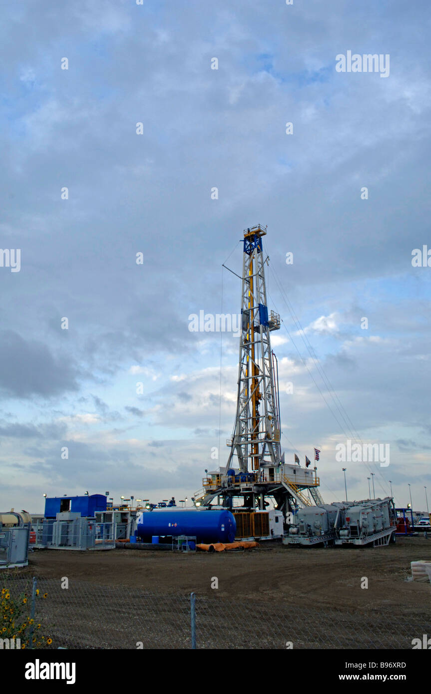 Oil derrick/drilling rig or gas well on public owned airport property signifies the intense search for fossil fuel and energy Stock Photo