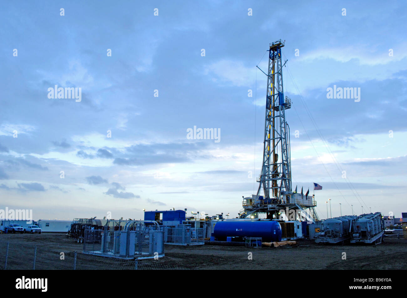 Oil derrick/drilling rig or gas well on public owned airport property signifies the intense search for fossil fuel and energy. Stock Photo