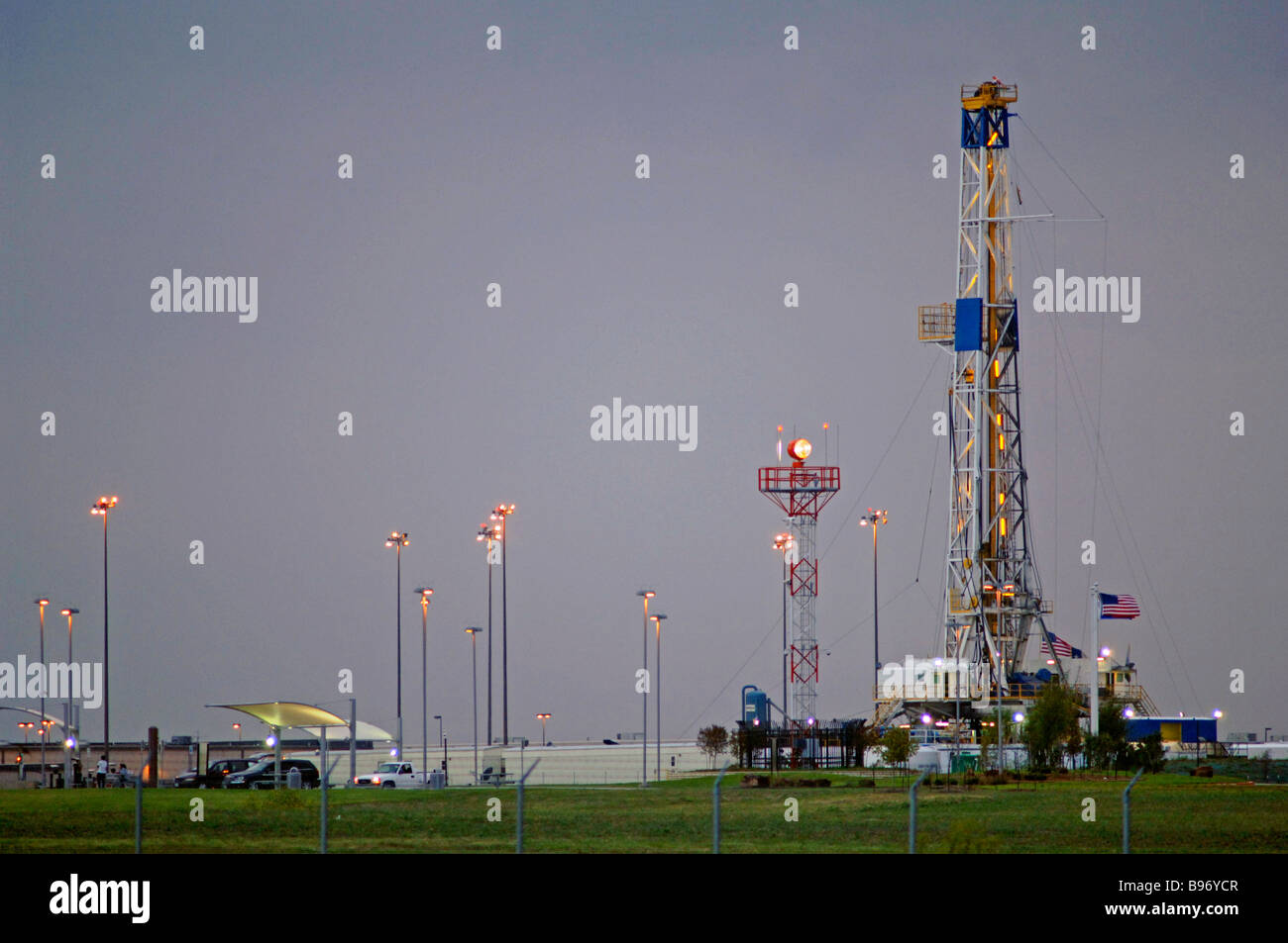 Oil derrick/drilling rig or gas well on public owned airport property signifies the intense search for fossil fuel and energy. Stock Photo