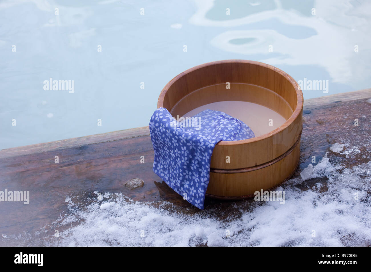 Hot spring and towel on wooden tub Stock Photo