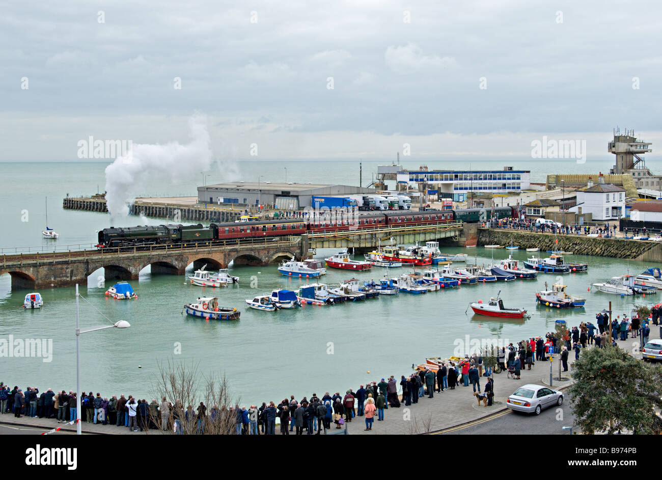 Folkestone Harbour lined by spectators watching 70013 'Oliver Cromwell' leave with probably the last train on the branch Stock Photo