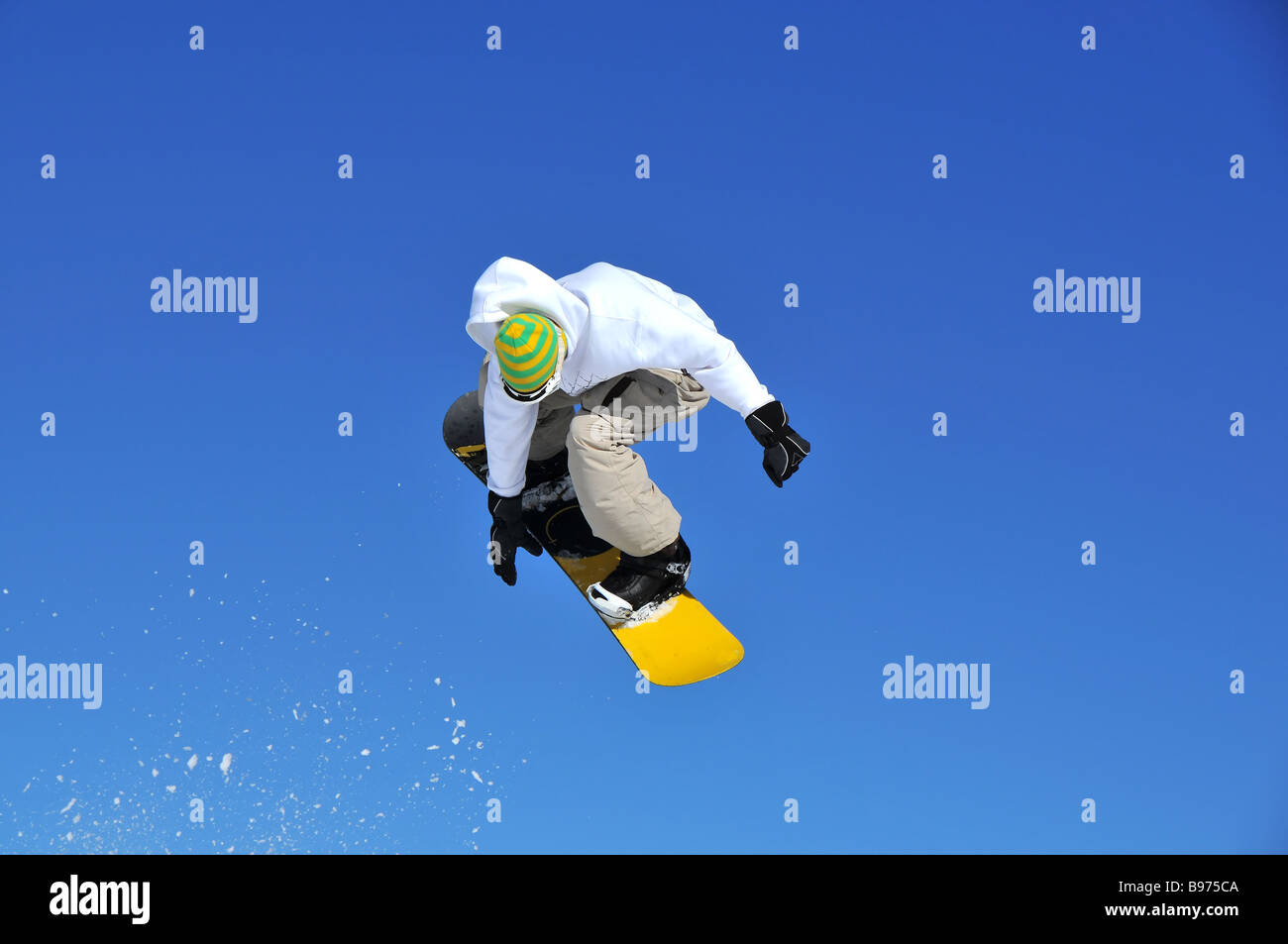 a snowboarder performing a jump Stock Photo