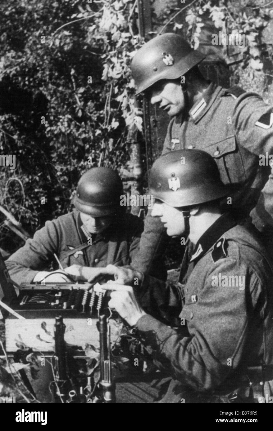 ENIGMA German cypher machine being operated by Wehrmacht troops during WW2 Stock Photo