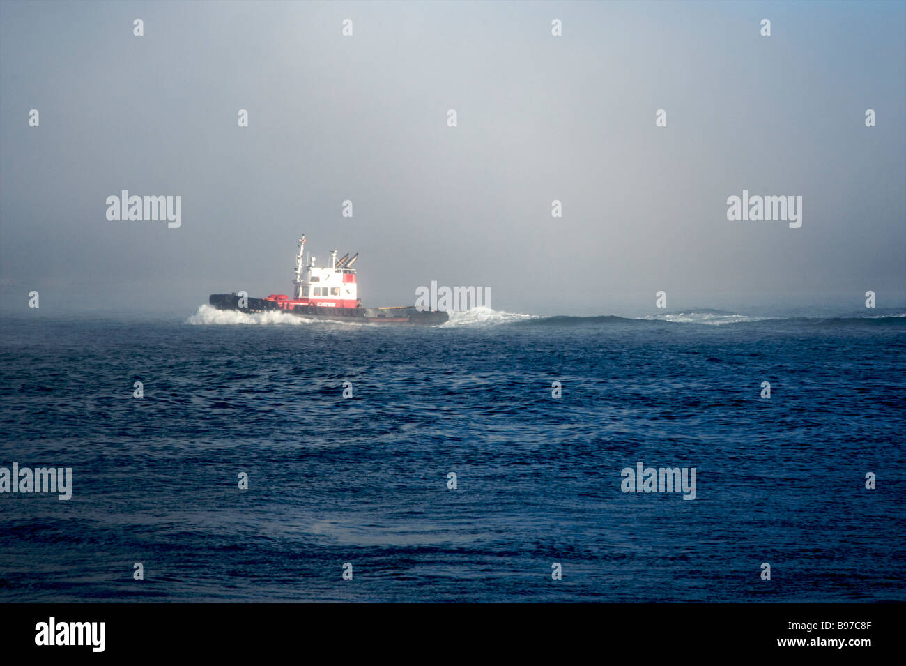 Tugboat moving through fog, Vancouver, British Columbia Stock Photo