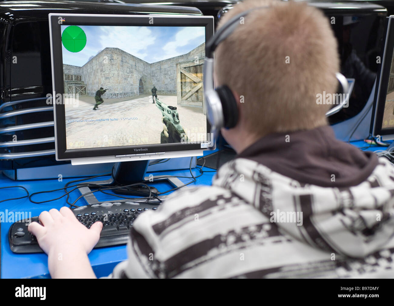 Teenager playing a violent game egoshooter at the computer Stock Photo