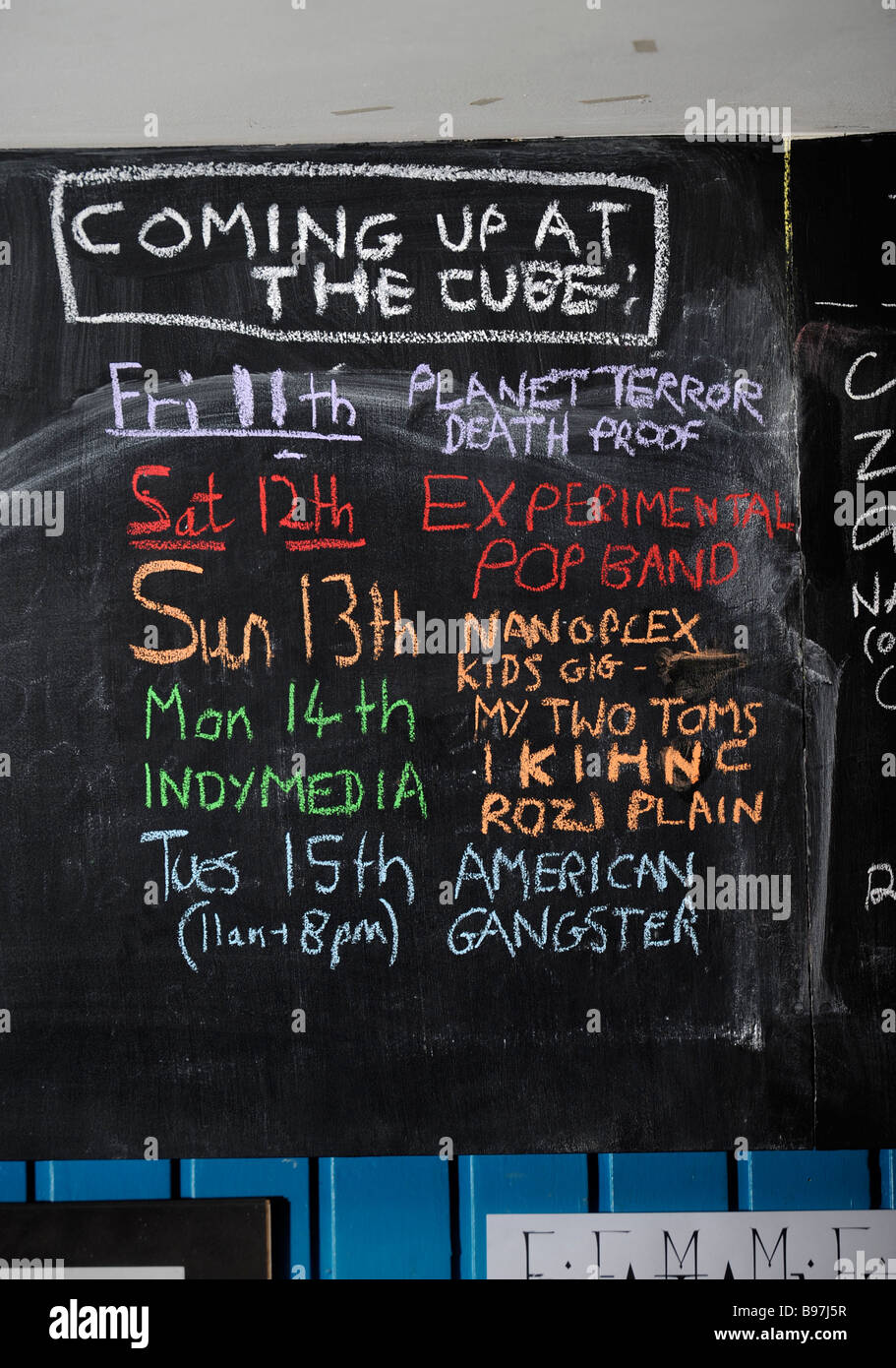 BLACKBOARD WITH THE SCHEDULE OF FILMS CHALKED UP AT THE CUBE MICROPLEX