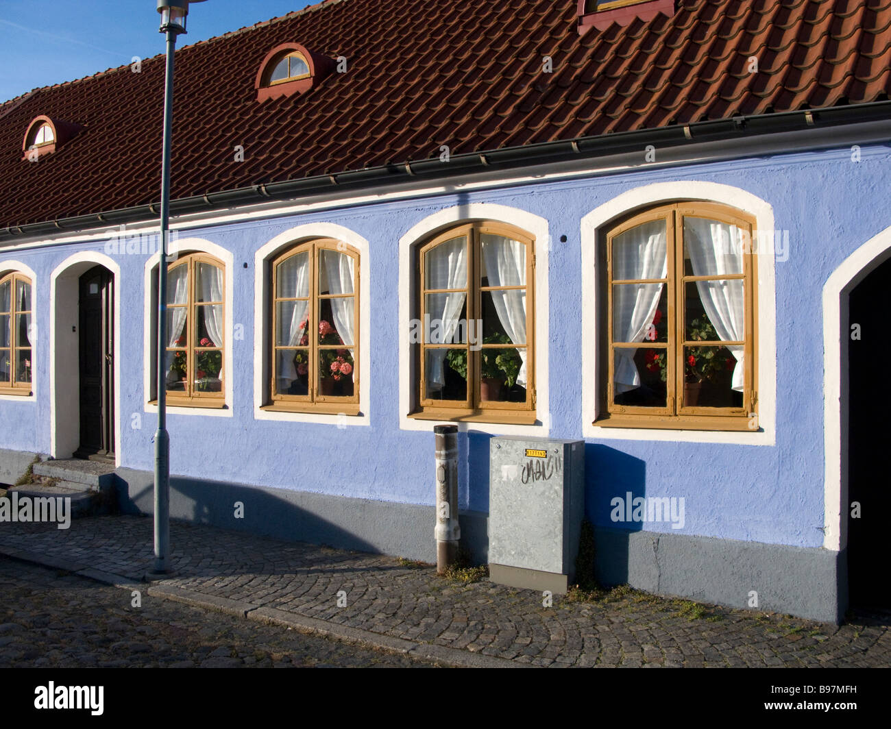 Old bluee house with curtains Stock Photo