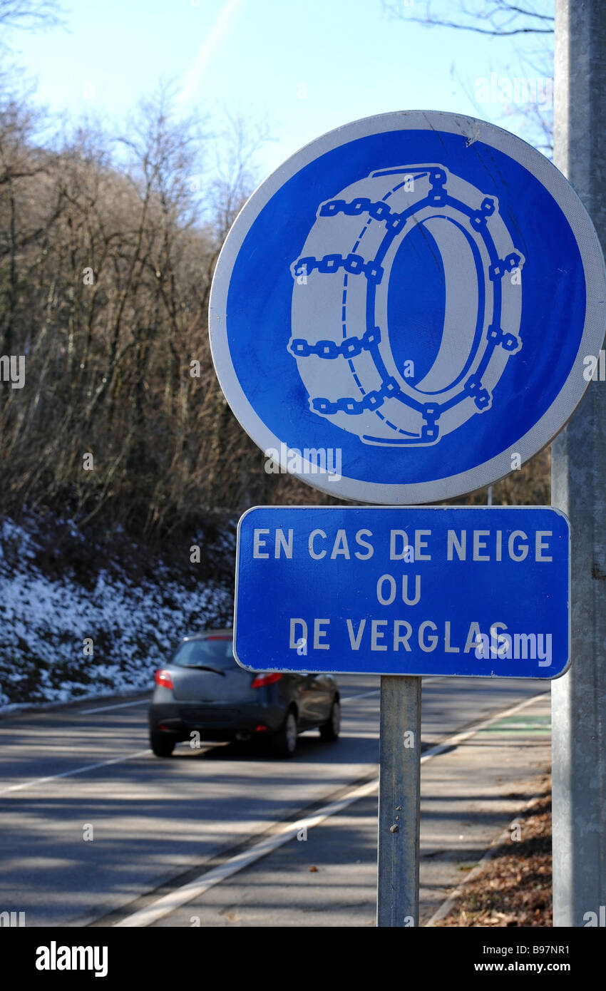 French roadsign suggesting the use of snow chains The English translation of the sign is In case of snow or ice Stock Photo