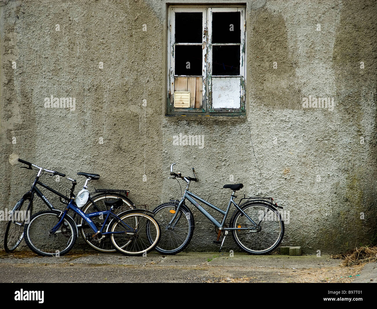 Slum Window Old bikes outside slum building with broken window Stock Photo - Alamy