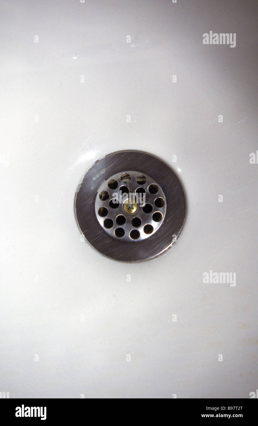 Plumber using drain snake to unclog bathtub Stock Photo - Alamy