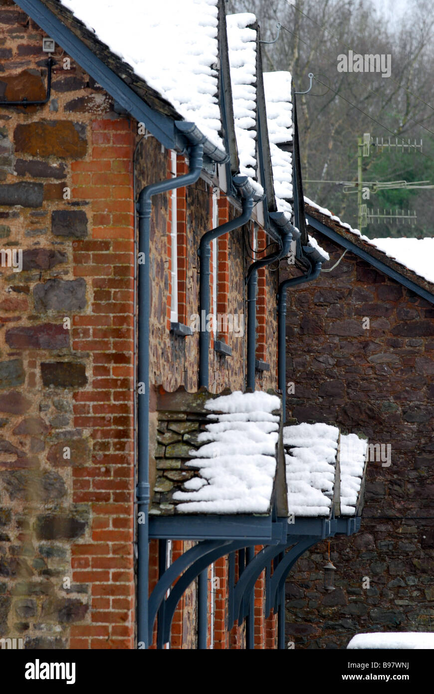 A dusting of snow on the rooftops of houses on the National Trusts Knightshayes court estate in Devon Stock Photo
