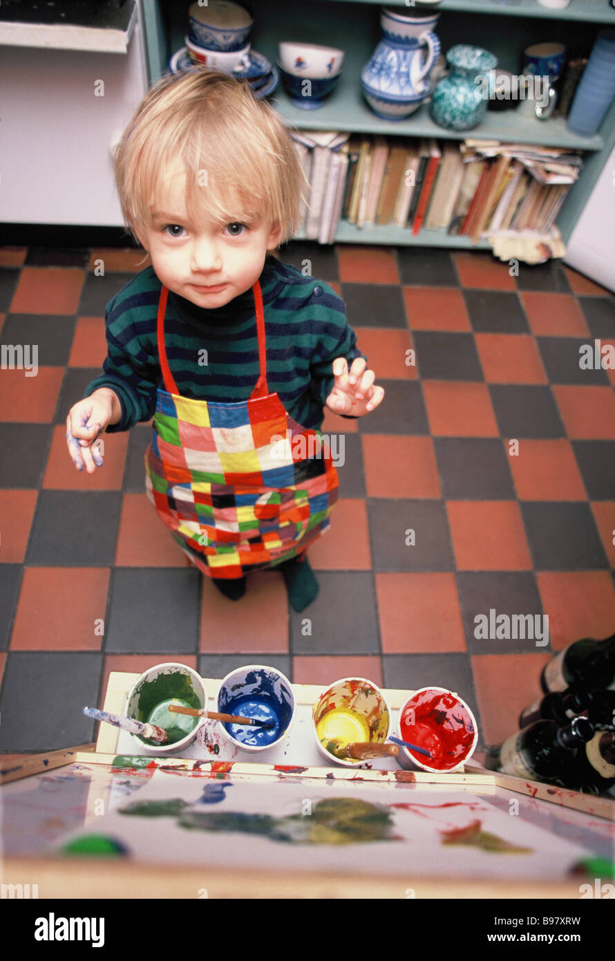 A young child painting in the kitchen Stock Photo Alamy