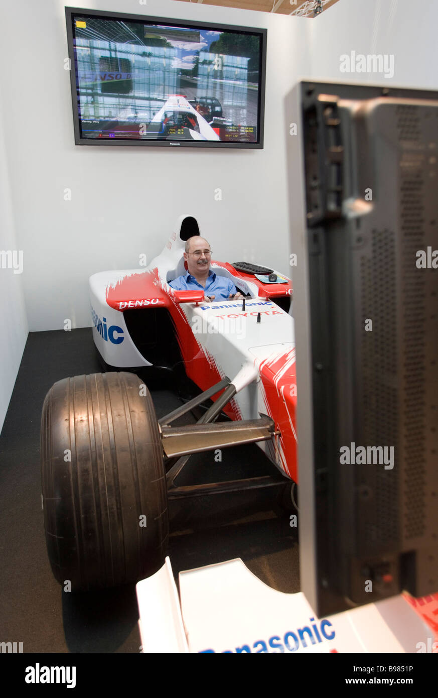 CeBIT visitor during a virtual motor racing in a racing car Stock Photo