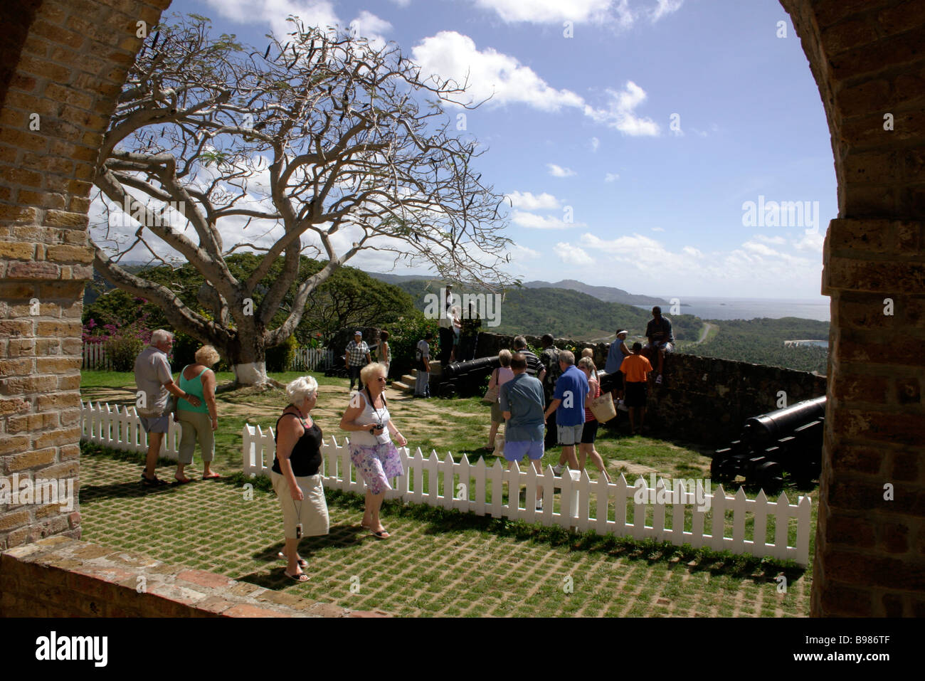 Fort King George British fort built in 1777 View over surrounding country People Tour party SCARBOROUGH TOBAGO Stock Photo