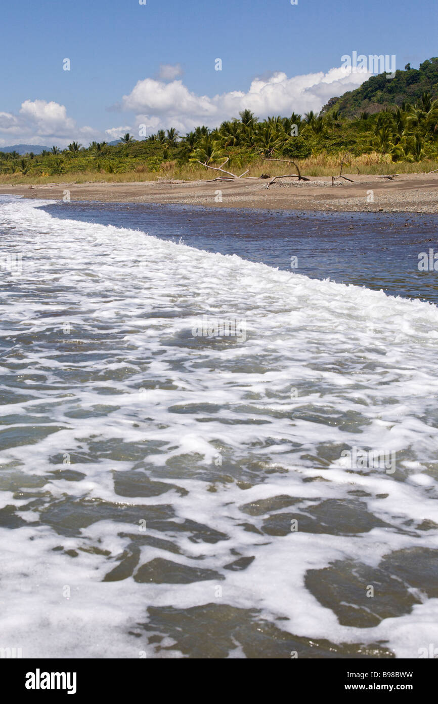 Wave washing onto the shore of Dominical, Costa Rica. Stock Photo