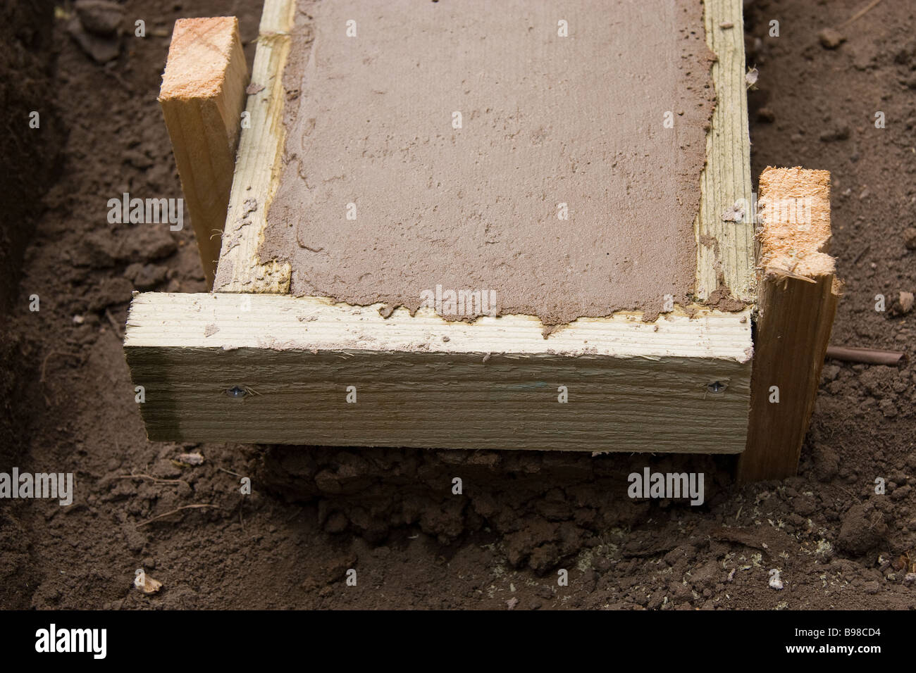 The picture shows that the concrete footings for a small garden wall