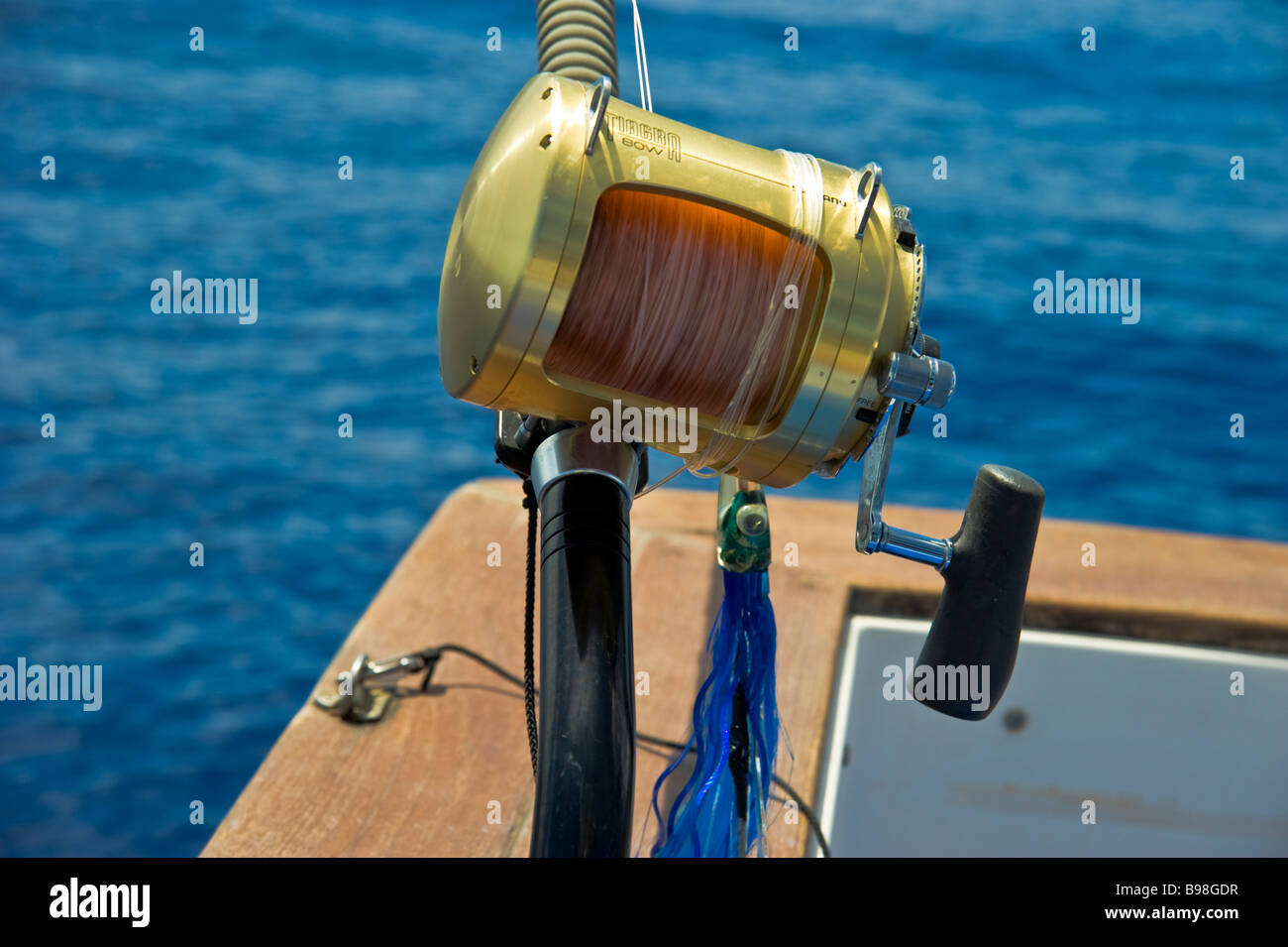 Fisching reel with lure on fishing boat La Réunion France | Rolle mit Köder und Angel auf Fischerboot, Hochseeangeln, La Réunion Stock Photo