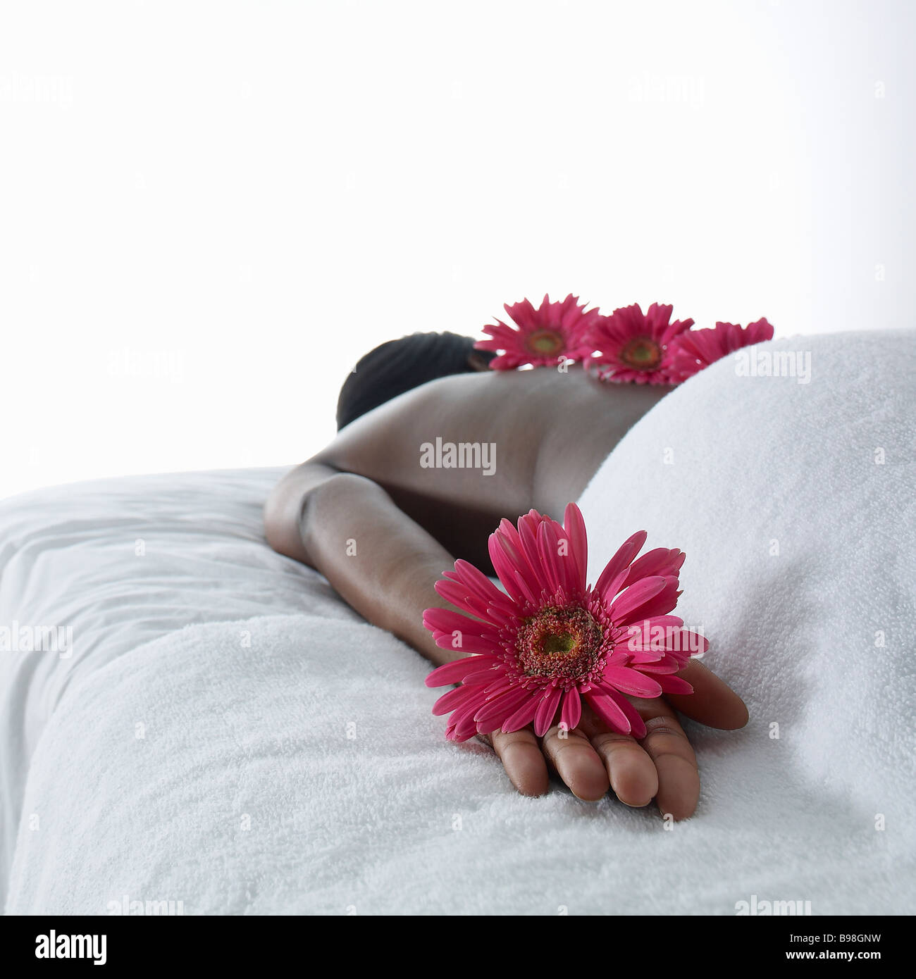 Black women laying on massage tables with flower Stock Photo